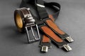 Fashionable men`s brown belt on dark with vintage suspenders