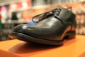 Fashionable men`s shoes are on the shelf of the store