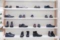 Fashionable men`s and women`s shoes on a stylish showcase in a boutique. Front view Royalty Free Stock Photo