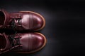 Fashionable mens leather brown shoes on black background. . Men's high boots. Top view. Copy space.