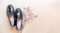 Fashionable minimalistic composition, women's black shoes with dried flowers.