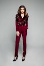 Fashionable model with brunette hair in bordo overall with desig