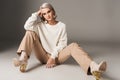 fashionable model posing in white sweater beige pants and autumn heels Royalty Free Stock Photo