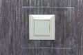 White switch with indicator in transparent plastic frame. Illuminated light switch. White switch with LED light. Royalty Free Stock Photo