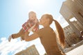 Fashionable modern mother on a urban street with a pram. Young m Royalty Free Stock Photo