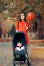 Mom Pushing Baby Stroller Holding a Red Balloon Royalty Free Stock Photo