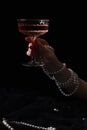 Fashionable photo of woman with glass of delicious wine against black background, closeup Royalty Free Stock Photo