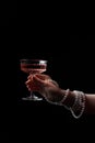 Fashionable photo of woman with glass of delicious wine against black background, closeup