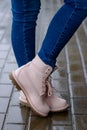 Fashionable pink boots on woman`s legs