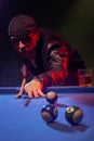 Fashionable pool player in a dark nightclub Royalty Free Stock Photo