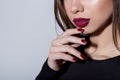 Fashionable portrait of a beautiful young woman with bright fashion red lipstick and bright evening make-up on a white Royalty Free Stock Photo