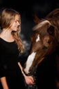 Fashionable portrait of a beautiful young woman and horse Royalty Free Stock Photo