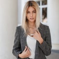 Fashionable portrait of a pretty stylish woman in a gray jacket