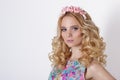 Fashionable portrait shot of beautiful girl cute blonde with curly hair wearing wreath flowers handmade Royalty Free Stock Photo