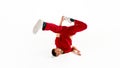 Fashionable portrait. Stylishly dressed young man dancing in freestyle, breakdance style in motion against white