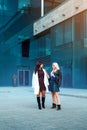 Fashionable ladies brunette and blonde looking at each othe Royalty Free Stock Photo