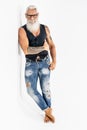 Fashionable sexy senior man with white beard and fit muscular body posing in studio