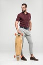 fashionable skater posing with longboard, Royalty Free Stock Photo