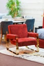 Fashionable soft red armchair with brass legs in gold color Royalty Free Stock Photo