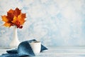 Fashionable stock autumn background - yellow leaves, red berries and a cup on blue. Royalty Free Stock Photo