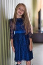 Fashionable style of clothes for children. Little little girl wearing a beautiful lace blue dress. Girl model with long hair