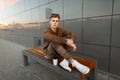 Fashionable stylish young man in a sweater with military pants Royalty Free Stock Photo