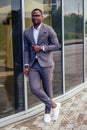 Fashionable and successful African businessman American handsome man in a stylish luxury suit posing on the street Royalty Free Stock Photo