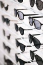 Fashionable sunglasses on a shelf in store Royalty Free Stock Photo