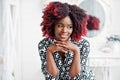 Fashionable tall african american model woman with red afro hair in dress Royalty Free Stock Photo