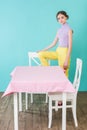 fashionable teen girl posing at table and chairs in dining