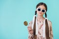 fashionable teen girl in sunglasses with braids holding lollipop Royalty Free Stock Photo