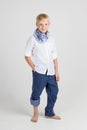 Fashionable teenager boy in blue scarf smiles Royalty Free Stock Photo