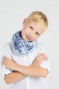 Fashionable teenager boy in blue scarf smiles Royalty Free Stock Photo