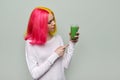 Fashionable teenager girl with glass of fresh green smoothies Royalty Free Stock Photo