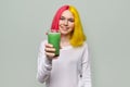 Fashionable teenager girl with glass of fresh green smoothies Royalty Free Stock Photo