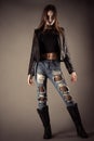 Fashionable teenager girl in leather jacket and torn jeans Royalty Free Stock Photo