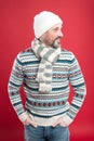 Fashionable wear for chilly season. Happy man in fashionable winter style red background. Mature man smile in