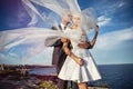 Fashionable wedding couple near ocean. Bride and Groom. Outdoor portrait