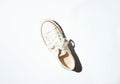 Fashionable white sneaker on white background. Photo with shadows, hard light, top view.