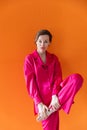 Beautiful fashionable woman in crimson silk pajamas Royalty Free Stock Photo