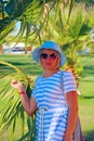 Fashionable woman in hat and sunglasses enjoying summer vacations