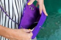 Fashionable woman holding luxury snakeskin python bag. Elegant outfit. Close up of purse in hands of stylish lady. Model Royalty Free Stock Photo