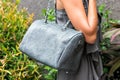 Fashionable woman holding luxury stylish snakeskin python bag. Elegant outfit. Close up of purse in hands of stylish Royalty Free Stock Photo