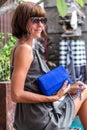 Fashionable woman holding luxury stylish snakeskin python bag. Elegant outfit. Close up of purse in hands of stylish Royalty Free Stock Photo