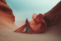 Fashionable woman in a long dress and a veil in the windy desert.