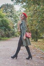 Fashionable woman in red beret with red handbag outdoors, fashion portrait