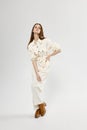 fashionable woman shopping white jumpsuit and brown boots hairstyle Royalty Free Stock Photo