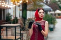 A fashionable woman with sunglasses, in a red dress, leather gloves, tights, red shoes and a scarf Royalty Free Stock Photo