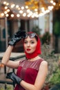 Woman with sunglasses, stands beautifully on the street of the evening city with illumination Royalty Free Stock Photo