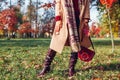 Fashionable woman wearing stylish clothes shoes and accessories walking in fall park. Autumn female outfit.